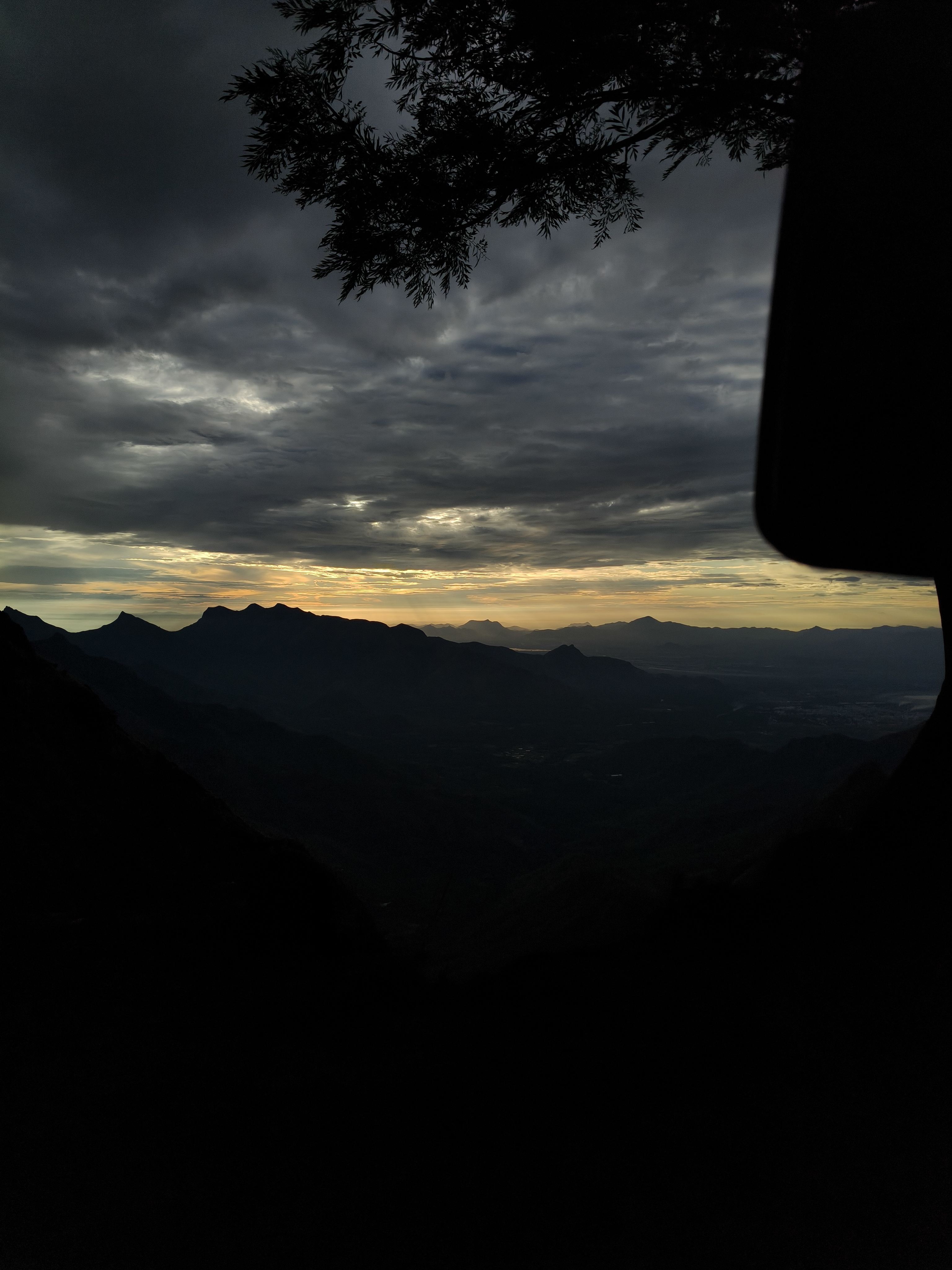 Kolukkumalai cloudy evening sky with mountain ranges and tree shadows